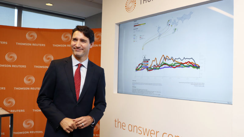 Canada's Prime Minister Justin Trudeau views a data screen during a visit to Thomson Reuters executive offices in Toronto